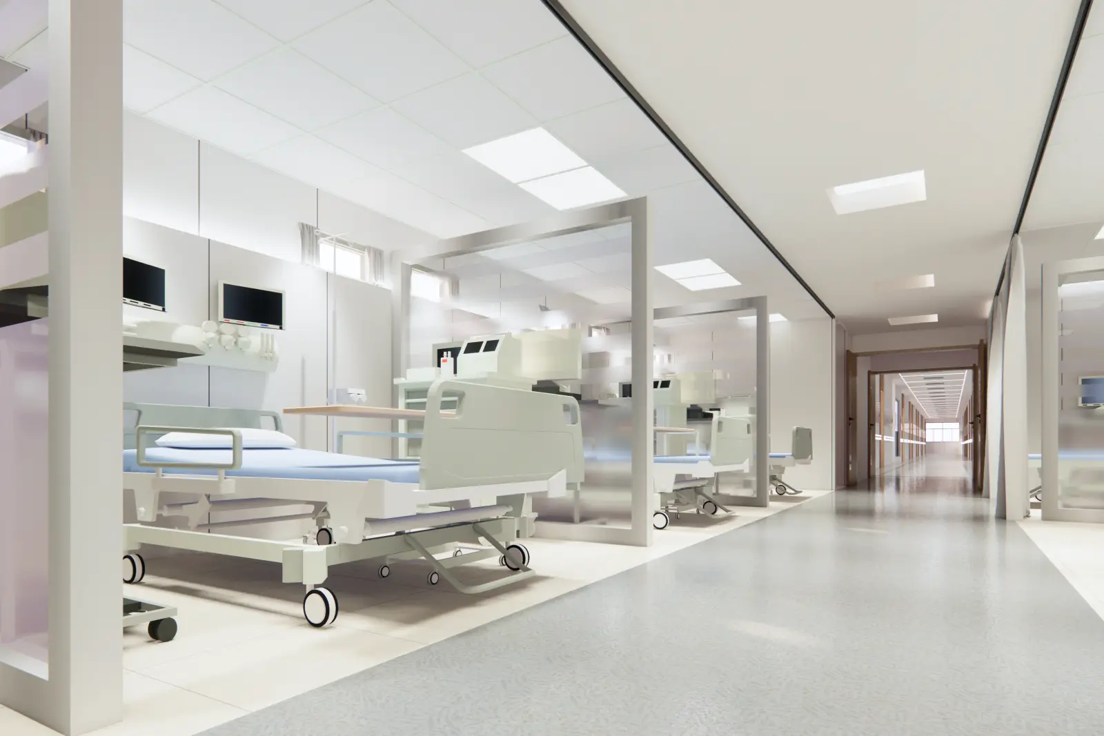 A bright recovery area with patient beds in glass-partitioned bays along a corridor.
